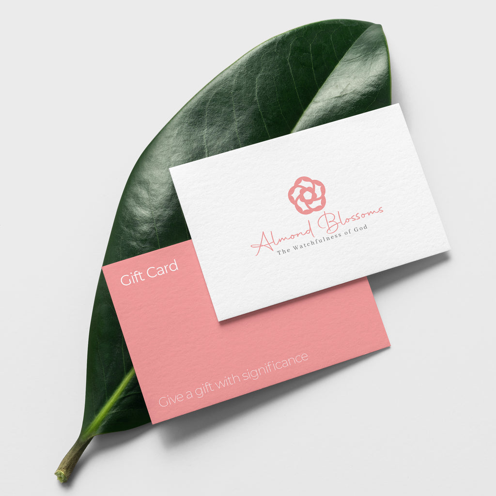 Our Almond Blossoms Gift Card with our logo in one side and text on the other. Both are on top of a green leaf.