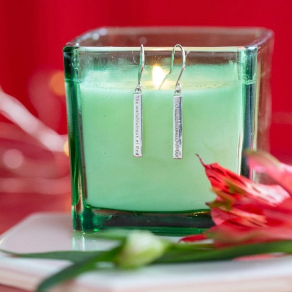 Sterling Silver Earrings on a green candle