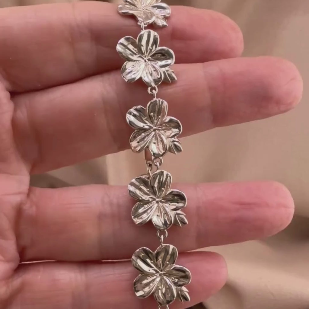 Sterling silver Christian bracelet  of a floral almond blossoms design on  woman's hand showcasing details 