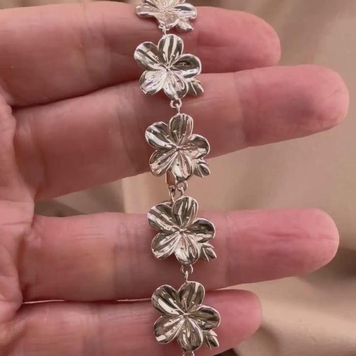 Sterling silver Christian bracelet  of a floral almond blossoms design on  woman's hand showcasing details 