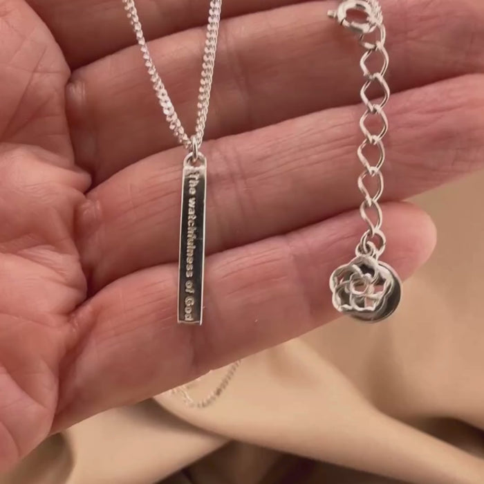 Video of our Watchfulness of God Bar Necklace in Sterling silver showing the details of this Christian necklace displayed on the hand of a woman.