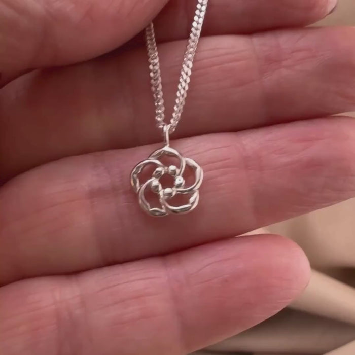Video of our Amond blossoms Necklace - Chosen and Seen in Sterling silver showing the details of this Christian necklace displayed on the hand of a woman.