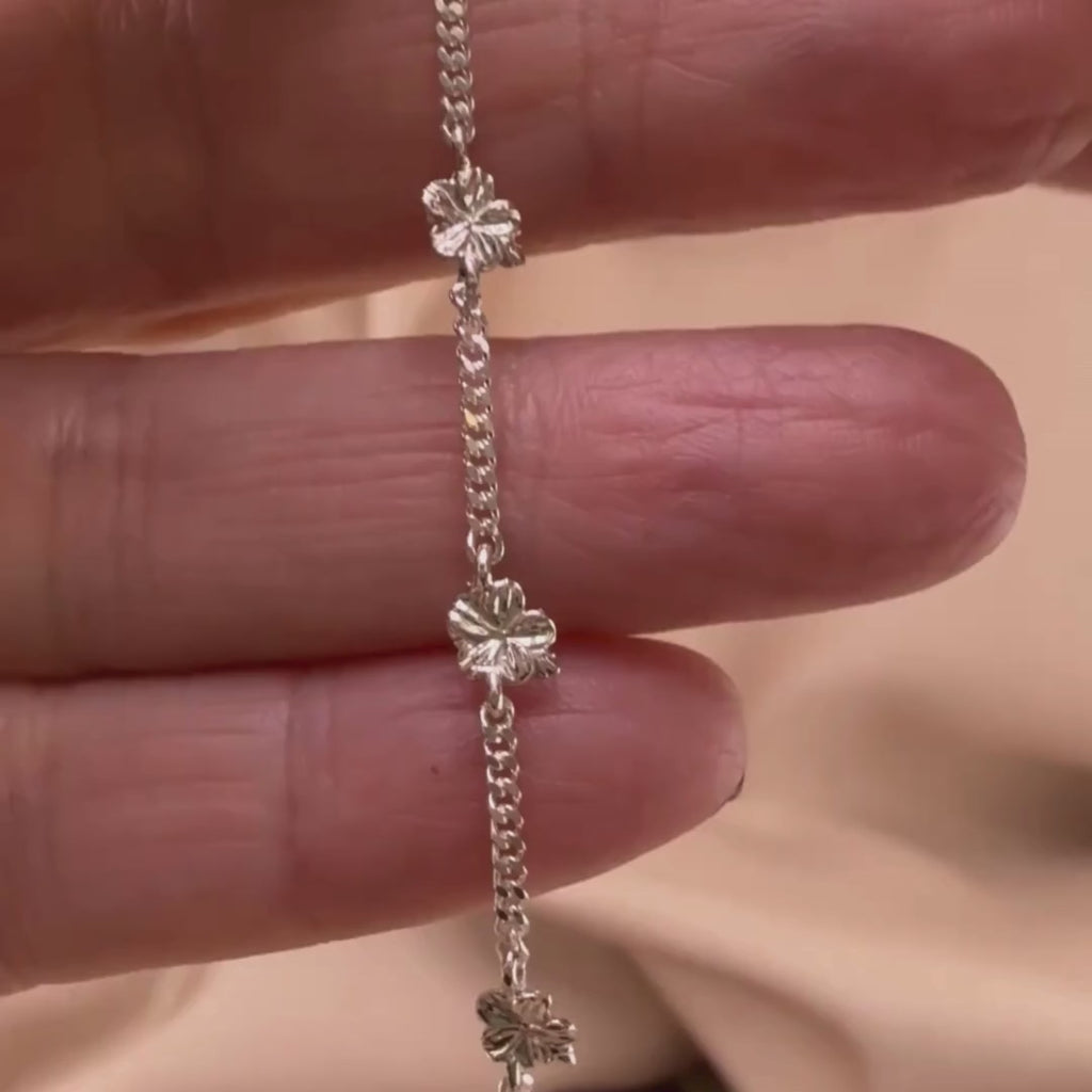 Sterling silver Christian bracelet  of a floral almond blossoms design on  woman's hand showcasing details 