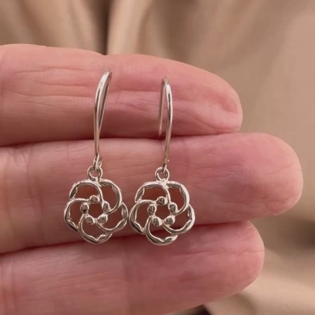 Video of almond blossom earrings in Sterling silver, showing the details of these Christian earrings displayed on the hand of a woman.