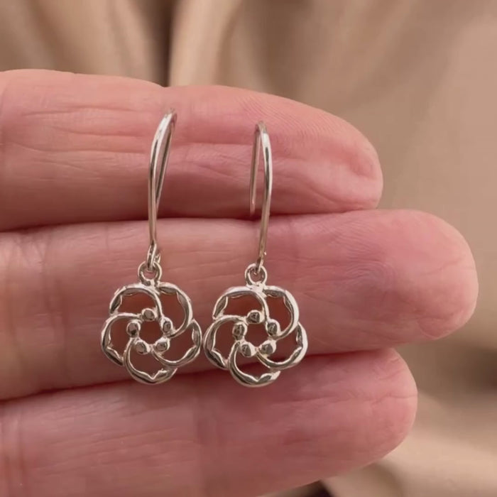 Video of almond blossom earrings in Sterling silver, showing the details of these Christian earrings displayed on the hand of a woman.