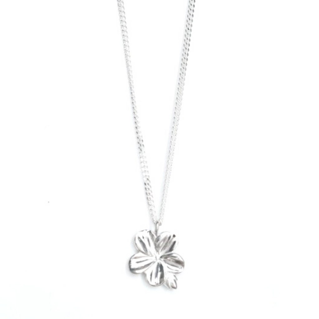 Stunning Mary Magdalene Christian necklace of an almond blossom and bud in sterling silver inspired by the meaning of the almond blossom in the Word of God and serves as a reminder of His watchfulness over your life. Necklace on a white tile background